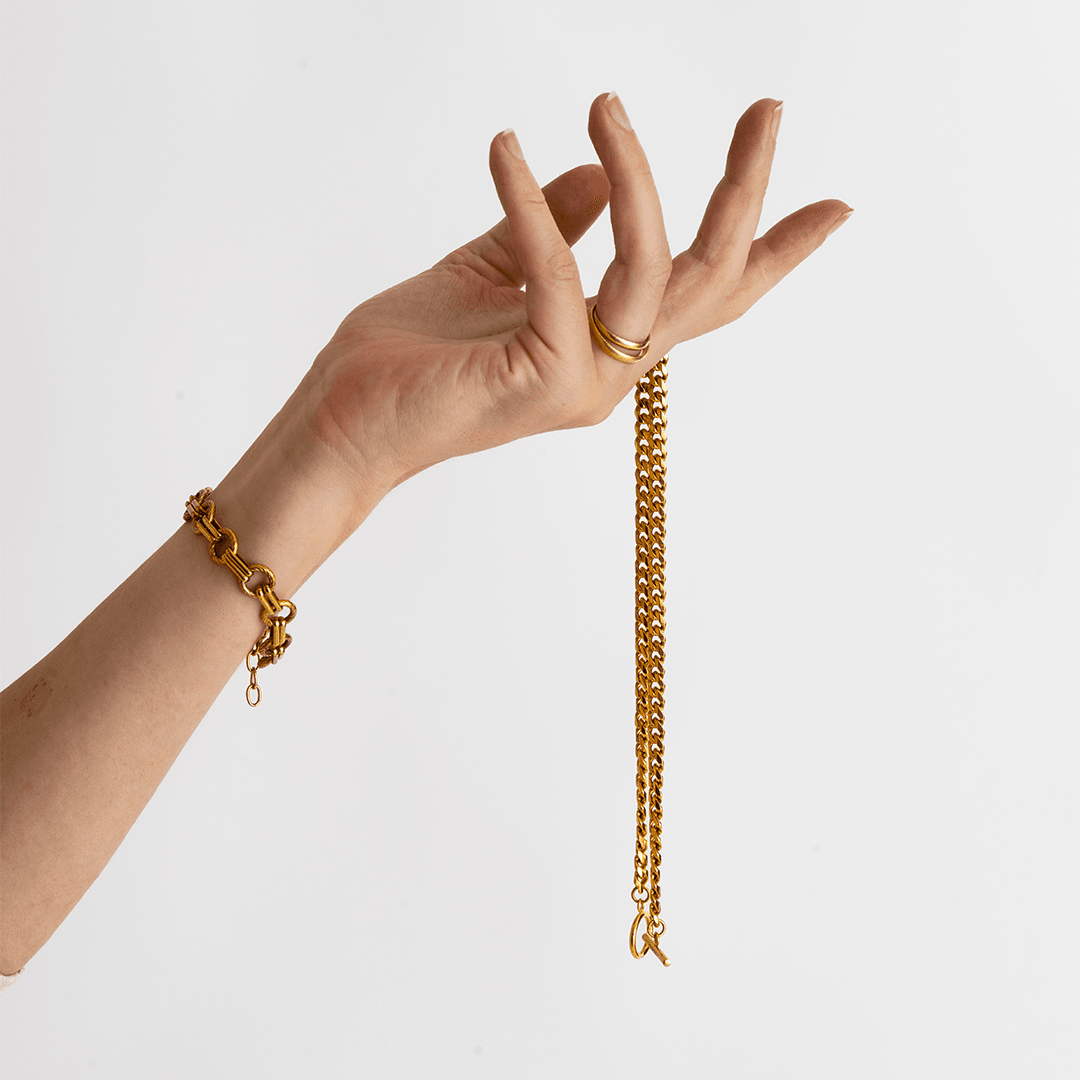 Hand wearing gold chains retouched for e-commerce