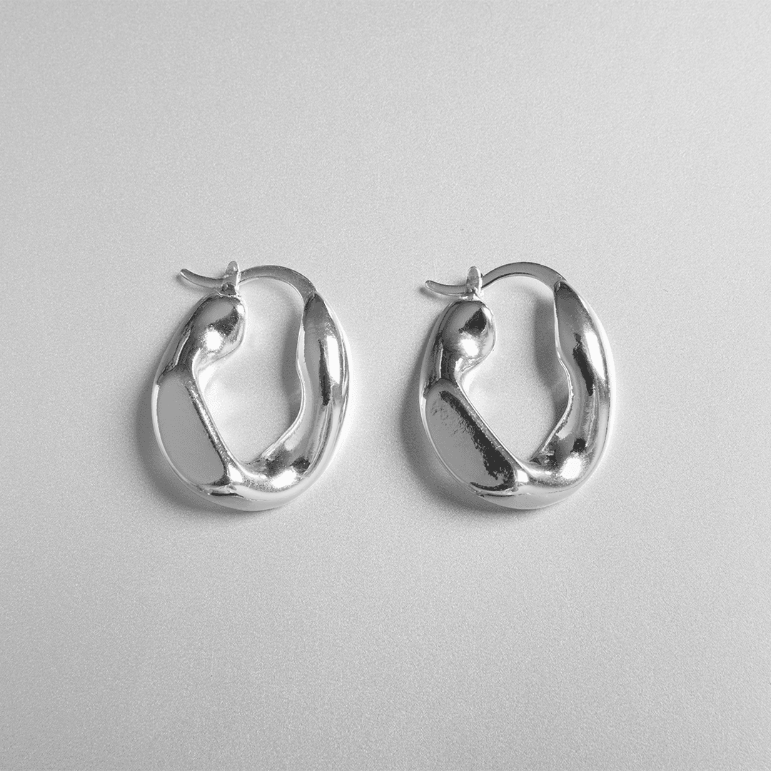 Sparkling gemstone stud earrings retouched for e-commerce