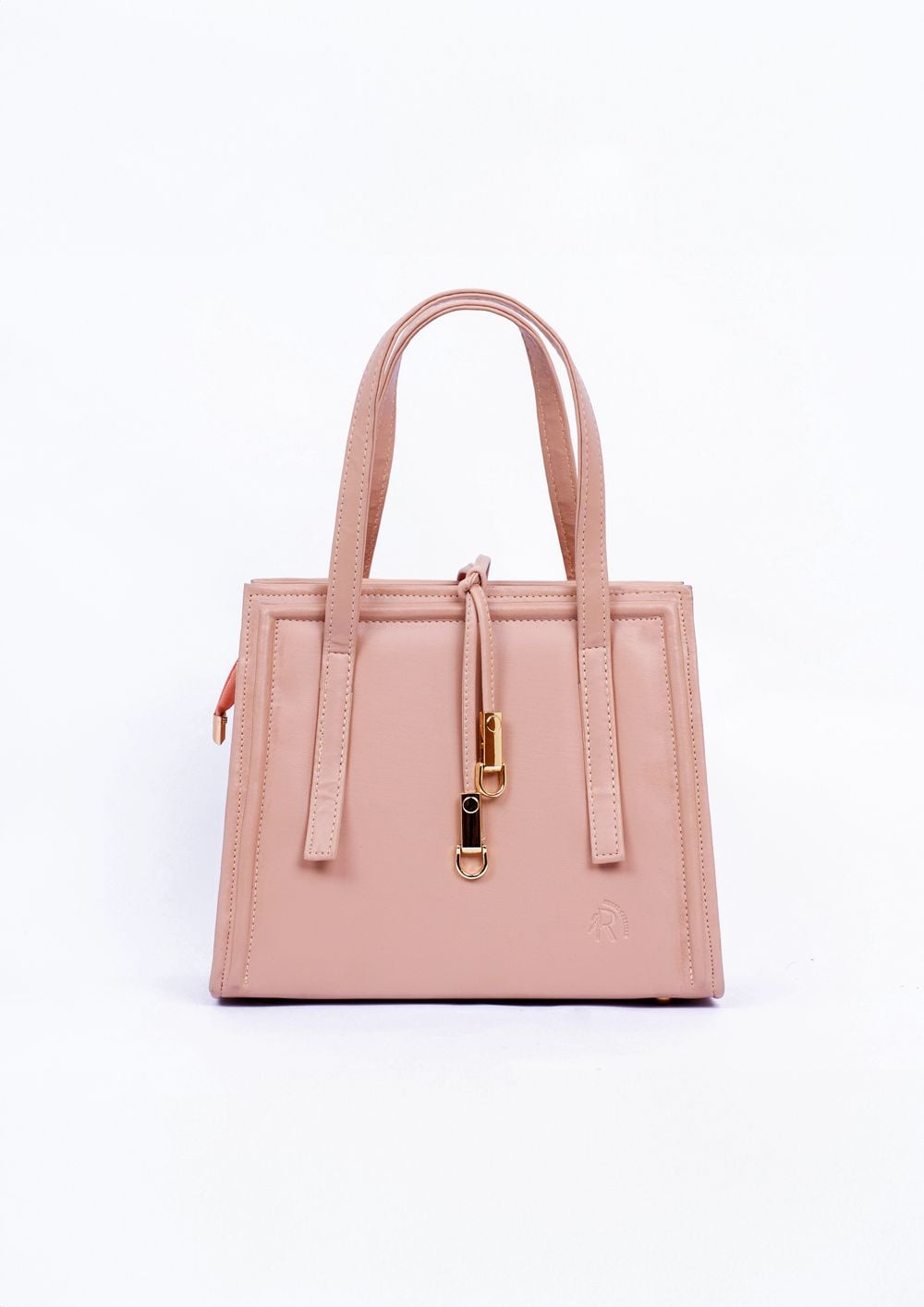 Pink leather tote photographed against a light studio background