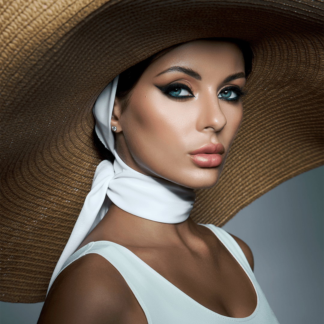 Beauty campaign portrait with bold eye makeup and styled headwear