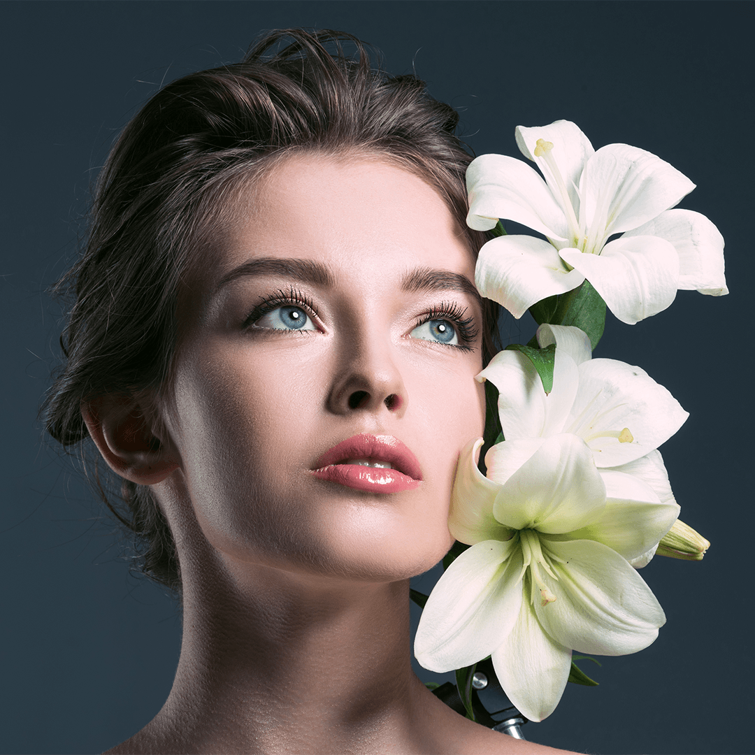 Beauty campaign portrait with bold eye makeup and styled headwear